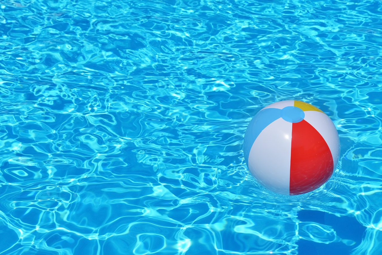 Colorful inflatable ball floating in swimming pool